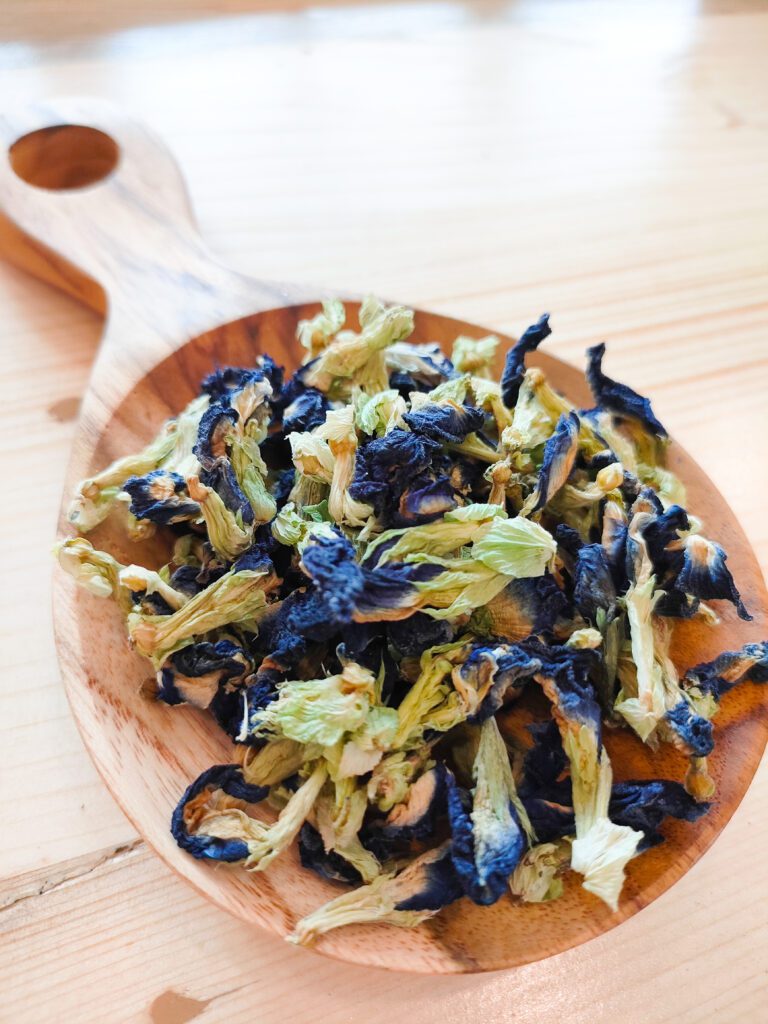 Butterfly Pea Tea on a wooden spoon