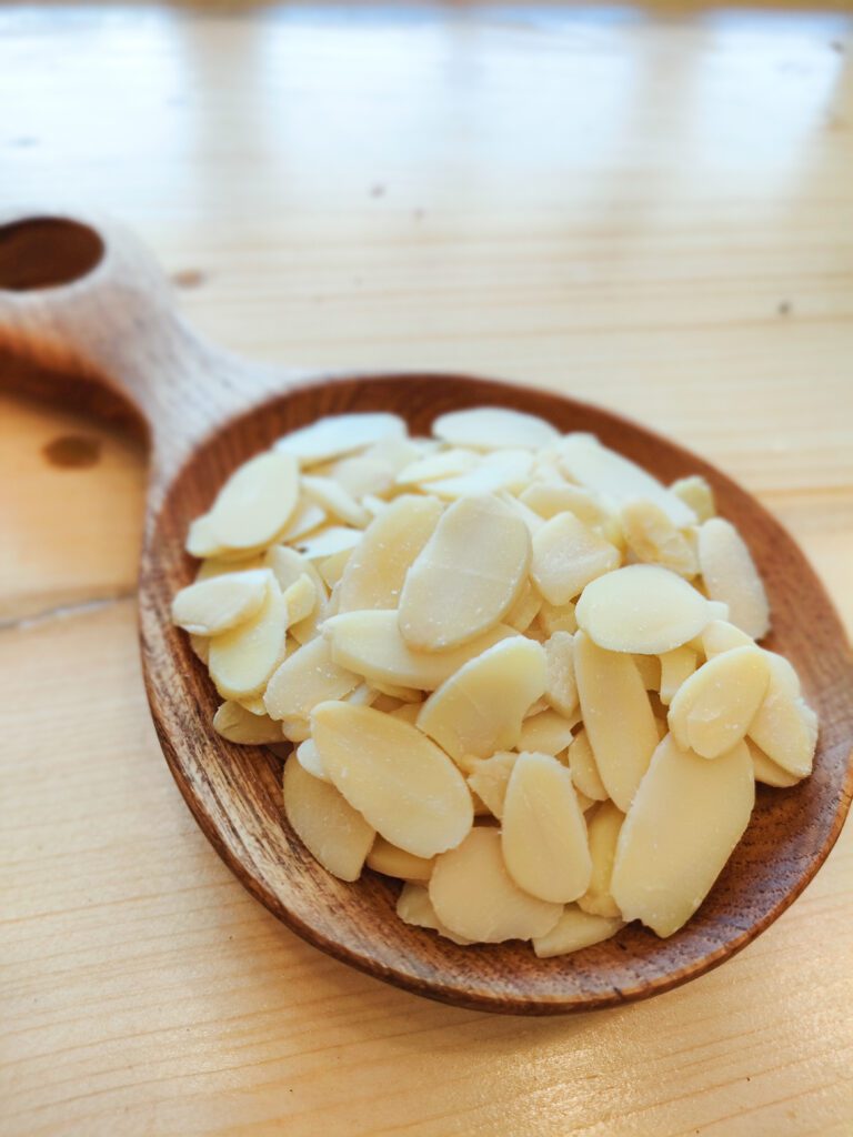 Sliced Almonds on a wooden spoon